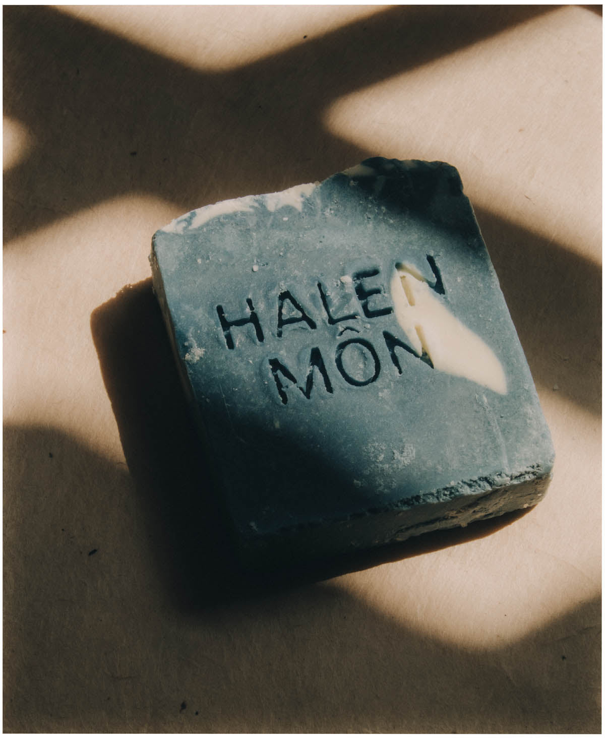 A bar of Halen Môn cold-process soap embossed with the maker's mark